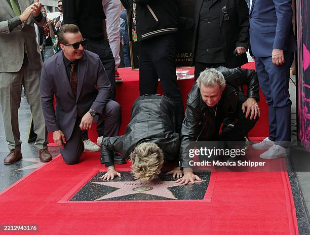 Tré Cool, Billie Joe Armstrong and Mike Dirnt of Green Day pose with their star during their Hollywood Walk of Fame Star Ceremony on May 01, 2025 in...