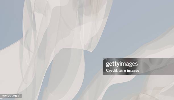 white sheer curtains flowing in the wind against a light blue sky - curtain blowing stock pictures, royalty-free photos & images