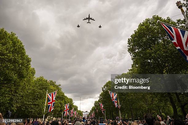 An RC-135W Rivet Joint surveillance aircraft flanked by two F-35 Lightning jets perform a fly past over The Mall during the VE Day 80 procession in...
