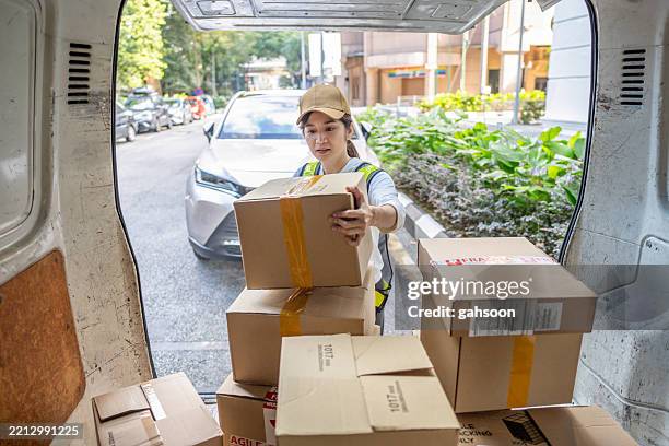 delivery person unloading stuff from van - doorstep stock pictures, royalty-free photos & images