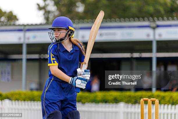 young female cricket player ready to bat - cricket team stock pictures, royalty-free photos & images