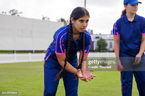 junior female cricketers practicing their fielding at training - indian cricket player stock pictures, royalty-free photos & images