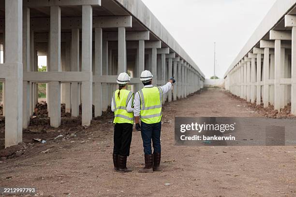 two civil engineer working at expressway work site - piling construction stock pictures, royalty-free photos & images