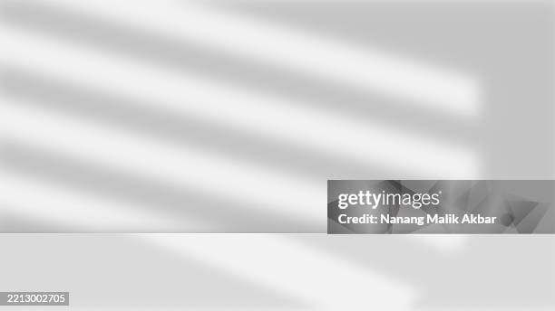 empty studio room with shadow and table for showing products - product spotlight stock illustrations
