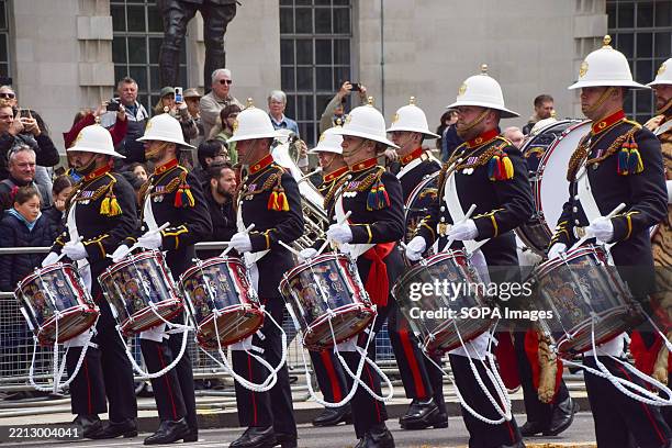 Military band passes through Whitehall during the VE Day parade, marking 80 years since the end of World War II in Europe.