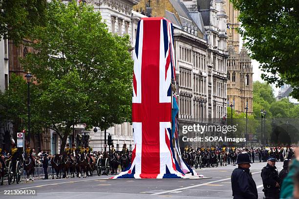 The VE Day parade passes by the Cenotaph war memorial draped in giant Union Jack flags in Whitehall, marking 80 years since the end of World War II...