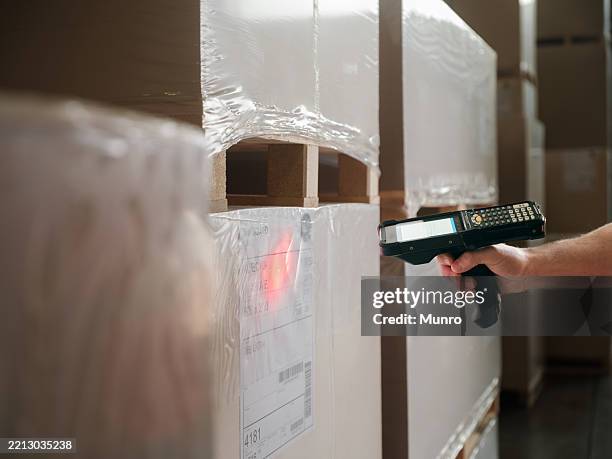 close-up of male hand scanning bar-code. - information equipment stock pictures, royalty-free photos & images