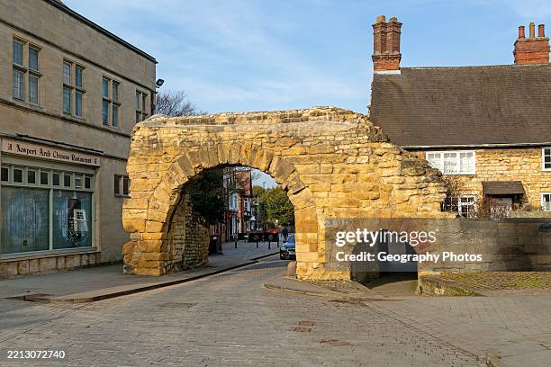 Newport Arch on Ermine Street, Roman entrance gateway to city of Lincoln, Lincolnshire, England, UK.