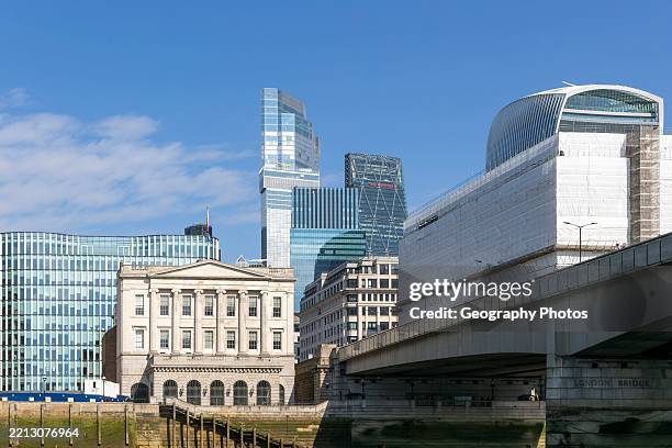 Fishmongers Hall next to London Bridge with skyscrapers behind, River Thames, London, England, UK 1.