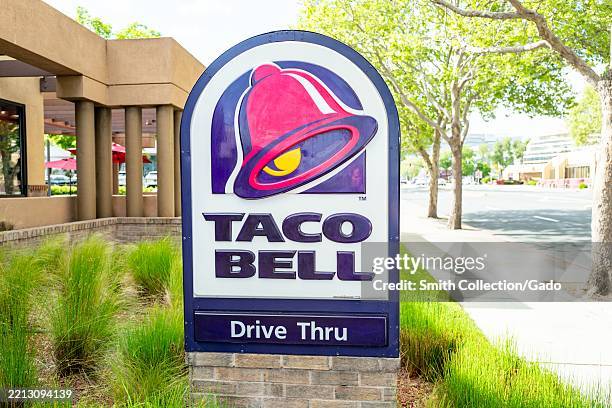 Close-up of Taco bell sign with drive thru signage also visible, Walnut Creek, California, April 8, 2025.