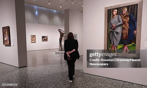 S Isabel Brown Wilson curator Alison de Lima Greene walks past Iréne and Her Sister by Tamara de Lempicka in an exhibit featuring the artist's work...