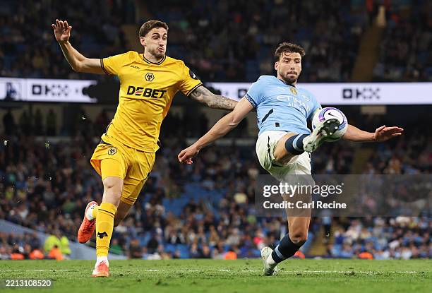 Ruben Dias of Manchester City controls the ball under pressure from