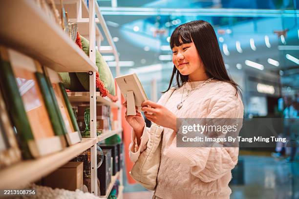 teen girl shopping for home decor in modern lifestyle store - gift shop stock pictures, royalty-free photos & images