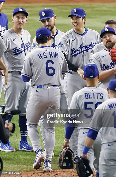 Shohei Ohtani of the Los Angeles Dodgers celebrates with teammates after defeating the Miami Marlins in a baseball game at loanDepot park in Miami,...