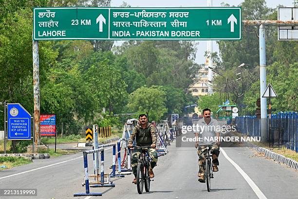 Indian Border Security Force personnel ride bicycles near the India-Pakistan Wagah border post, about 35kms from Amritsar on May 6, 2025....
