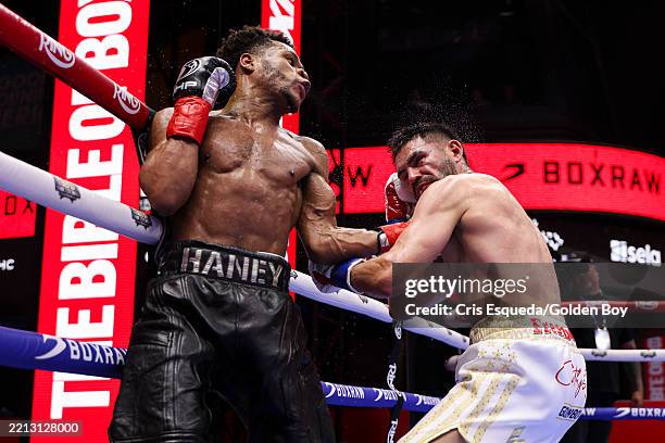 Devin Haney lands a punch on Jose Ramirez during a fight in Times Square on May 02, 2025 in New York City.