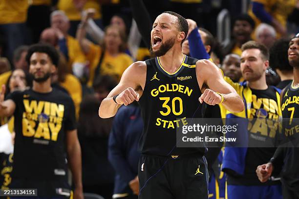 Stephen Curry of the Golden State Warriors celebrates a basket shot by Jimmy Butler III against the Houston Rockets during the second quarter in Game...