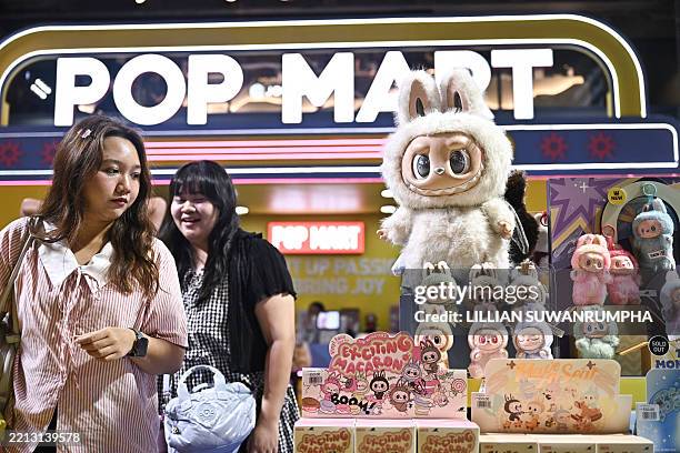 People look at collectable designer art toy Labubu at a Pop Mart pop-up store in Siam Center shopping mall in Bangkok on May 6, 2025.