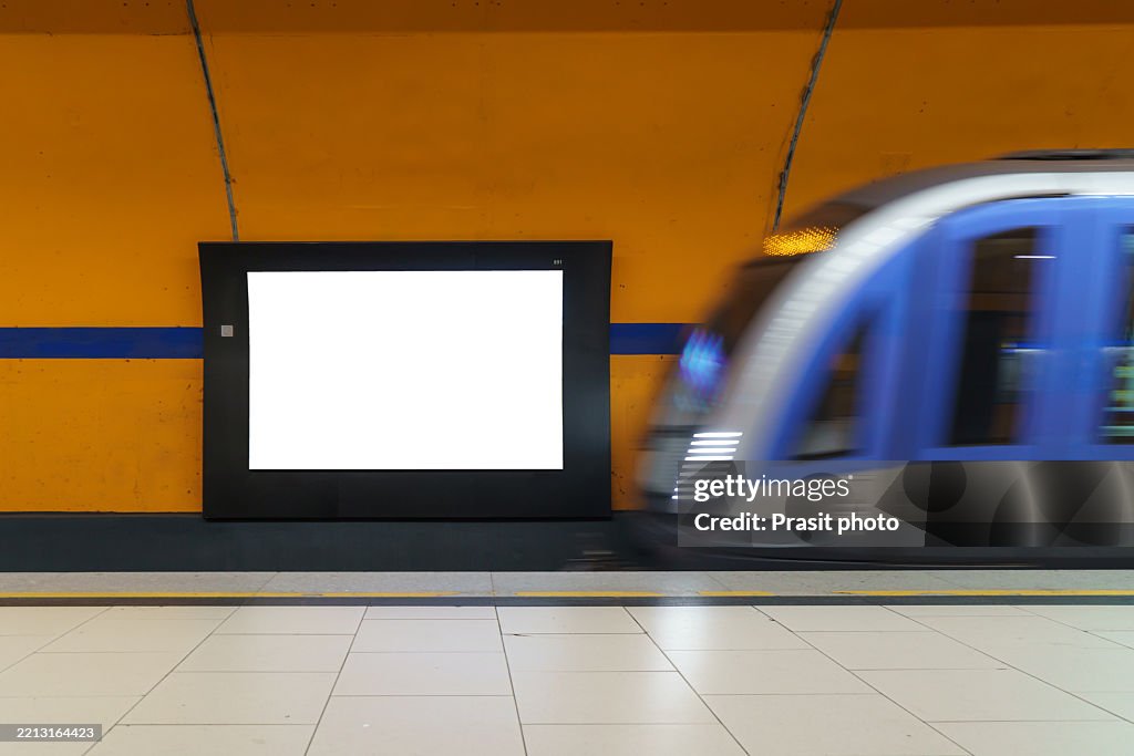 Blank Billboard and Arriving Train at Metro Station
