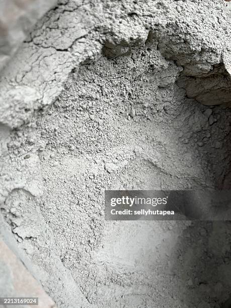 close-up of dry cement powder in bag – construction material texture background - sacchi cemento foto e immagini stock