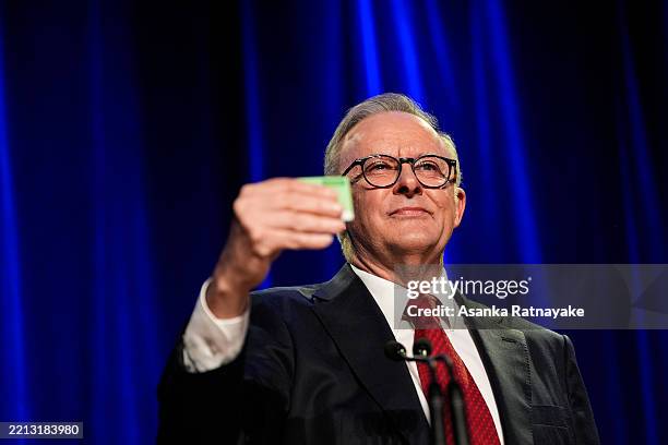 Prime Minister Anthony Albanese holds up his Medicare card during the Labor Party’s election night event on May 03, 2025 in Sydney, Australia. Prime...
