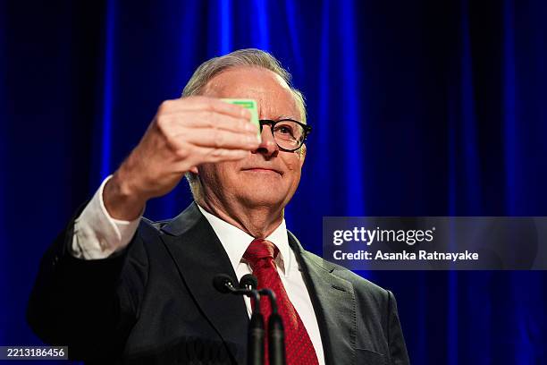 Prime Minister Anthony Albanese holds up his Medicare card during the Labor Party’s election night event on May 03, 2025 in Sydney, Australia. Prime...