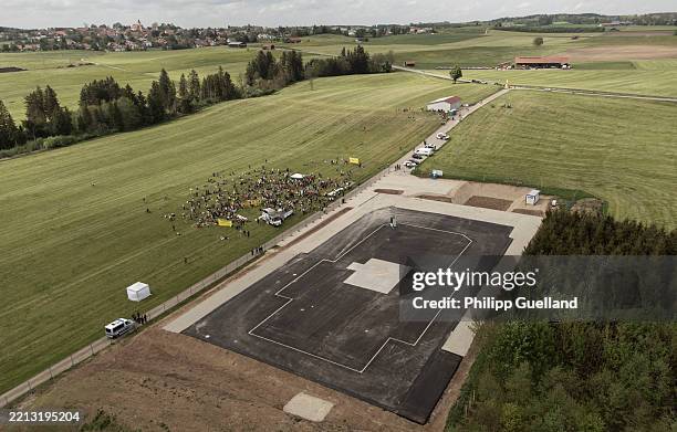 An aerial view shows people protesting against a new natural gas drilling site in Bavaria on May 3, 2025 near Reichling, Germany. Activists from a...