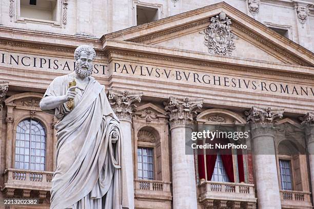 Statue of Saint Peter and the balcony where the new Pope will appear at St. Peter's Basilica a day ahead of the conclave. Vatican City, Italy on May...