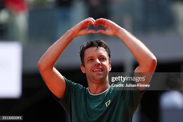 Horacio Zeballos of Argentina gestures a heart symbol to the fans as he celebrates victory with his partner Marcel Granollers of Spain following the...