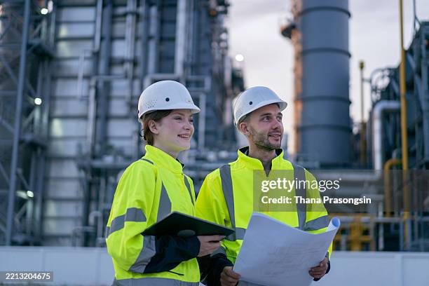 man and woman working late with laptop in a power plant. night shift. - nuclear power station stock pictures, royalty-free photos & images