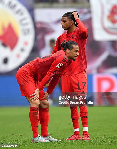 Leroy Sane of Bayern Munich looks dejected with teammate Michael Olise during the Bundesliga match between RB Leipzig and FC Bayern München at Red...