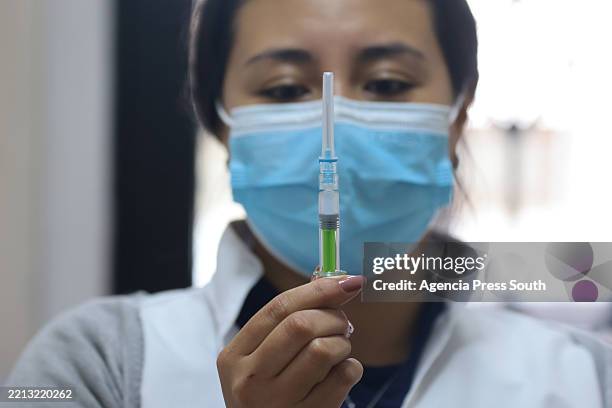 Health worker prepares a dose of Stamaril vaccine amid a whooping cough and yellow fever outbreak on May 6, 2025 in Quito, Ecuador. Ecuadorian health...