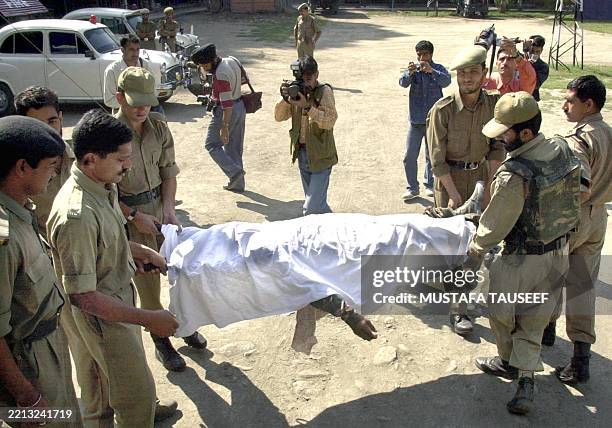 Indian Border Security Force soldiers transport the corpse of a slain militant believed to be a Pakistani and a member of the hardline Islamic group...