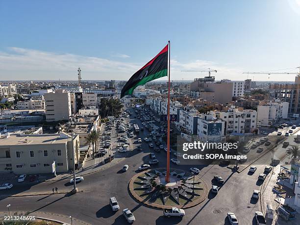 General view of the central square featuring the city's prominent flagpole. The image shows urban infrastructure and parts of the surrounding...