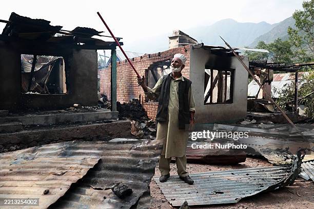 Lal Din shows the location from which the mortar shell comes and hits Sultan Mohammad Naik's house in Kamalkote, Uri, Jammu and Kashmir, India, on...