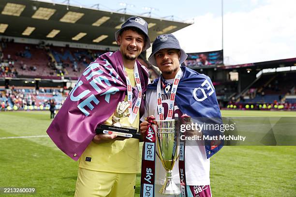 James Trafford of Burnley holds his golden glove trophy as he poses for a photo with teammate CJ Egan-Riley of Burnley who is holding the Sky Bet...