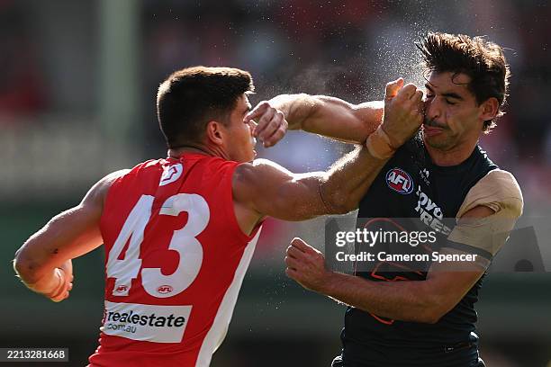 Lewis Melican of the Swans collides with Toby Bedford of the Giants during the round eight AFL match between Sydney Swans and GWS Giants at Sydney...