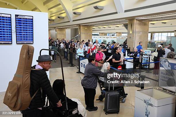 Santa Ana, CA Travelers wait in TSA lines as the Rela ID deadline - hits. They will not turn travelers without the Real ID away, but Wednesday is the...