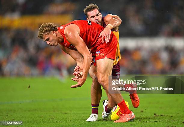Jed Walter of the Suns is tackled by Jack Payne of the Lions during the round eight AFL match between Brisbane Lions and Gold Coast Suns at The...