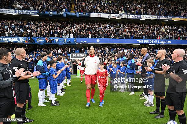 Virgil van Dijk of Liverpool leads his side out whilst receiving a guard of honour from players of Chelsea prior to the Premier League match between...