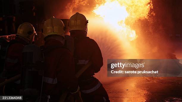 fireman team . - petrol canister stock pictures, royalty-free photos & images