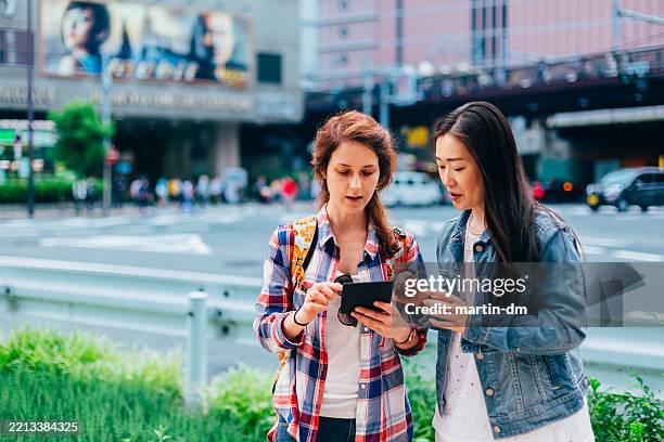 woman in osaka asking for direction a local woman - wonderlust imagens e fotografias de stock