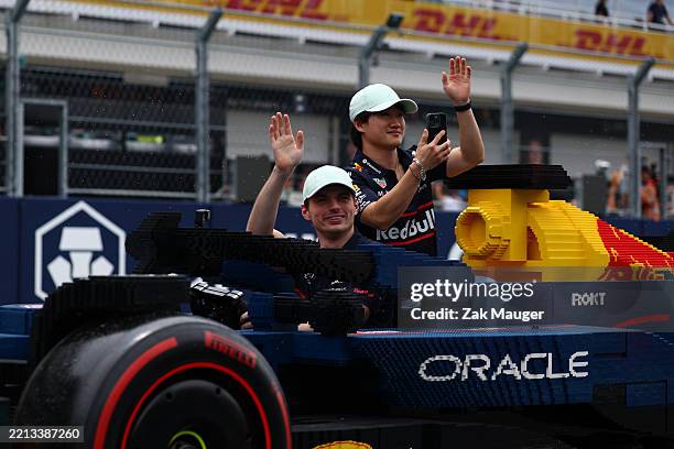 Max Verstappen of the Netherlands and Oracle Red Bull Racing and Yuki Tsunoda of Japan and Oracle Red Bull Racing at the Lego drivers parade prior to...