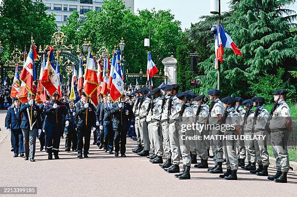 French Army flag bearers parade in front of soldiers during the national ceremony to commemorate the 80th anniversary of the victory of May 8, 1945...