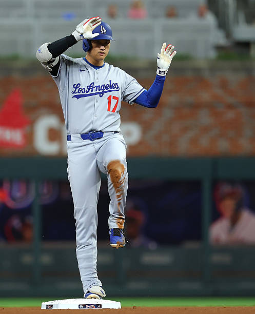 Shohei Ohtani of the Los Angeles Dodgers reacts after hitting a double in the seventh inning against the Atlanta Braves at Truist Park on May 04,...