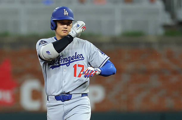 Shohei Ohtani of the Los Angeles Dodgers reacts after hitting a double in the seventh inning against the Atlanta Braves at Truist Park on May 04,...