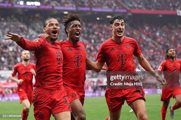 Leroy Sane of Bayern Munich celebrates scoring his team's third goal with teammates Kingsley Coman and Aleksandar Pavlovic during the Bundesliga...