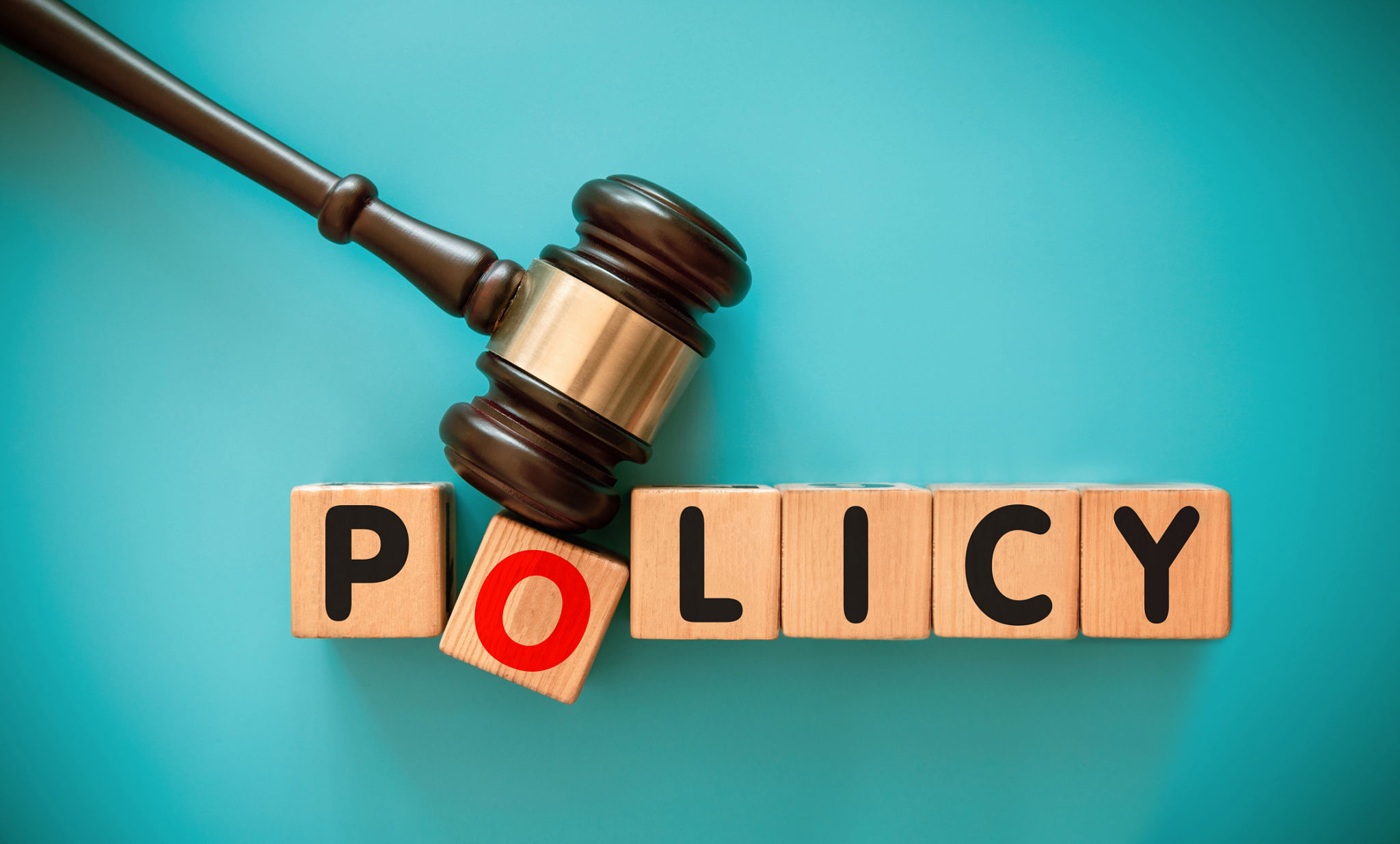 Gavel and wood block with POLICY or STRATEGY Gavel and wood block with POLICY or STRATEGY
