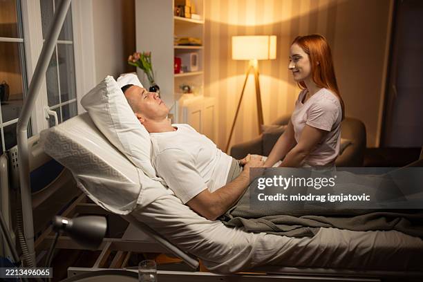 patient asleep with girlfriend by his side - boyfriend stock pictures, royalty-free photos & images