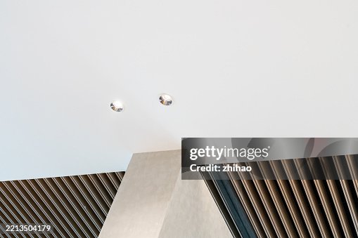 Two birds perched on a triangular structure against a clear sky. Two birds perched on a triangular structure against a clear sky.